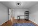 Bright bedroom with ample storage, wood-look floors, and a doorway leading to the rest of the home at 5200 Mrs Fuller Rd, Mebane, NC 27302