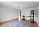 Large bedroom with an open floor plan, wood-look floors, and bright light fixtures throughout the home at 5200 Mrs Fuller Rd, Mebane, NC 27302