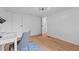 Bedroom features a desk, modern ceiling light, and wood look floors with blue accent rug at 5200 Mrs Fuller Rd, Mebane, NC 27302