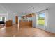 Cozy dining area features wood-look flooring, bead board, an elegant light fixture, and natural light at 5200 Mrs Fuller Rd, Mebane, NC 27302