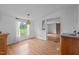 Open-concept dining area with wood-look floors, modern lighting, and convenient access to living areas at 5200 Mrs Fuller Rd, Mebane, NC 27302