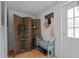Cozy entryway with bench, coat rack, screen divider, and wood laminate flooring at 5200 Mrs Fuller Rd, Mebane, NC 27302