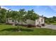 Exterior view of the home with well-manicured lawn and landscaping, mature tree in view at 5200 Mrs Fuller Rd, Mebane, NC 27302