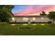 Front view of the home at dusk, featuring a landscaped yard and cozy lighting at 5200 Mrs Fuller Rd, Mebane, NC 27302