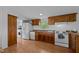 Bright kitchen features white appliances, wood cabinets, and a large window over the sink at 5200 Mrs Fuller Rd, Mebane, NC 27302