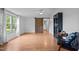 A living room with a window, ceiling fan, wood floors and a bookshelf with blue accents at 5200 Mrs Fuller Rd, Mebane, NC 27302