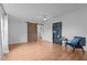Living room features ceiling fan, wood-look floors, sliding door, and bookshelf with a decorative chair at 5200 Mrs Fuller Rd, Mebane, NC 27302
