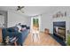 Comfortable living room with fireplace, ceiling fan, and sliding doors to the deck at 5200 Mrs Fuller Rd, Mebane, NC 27302