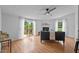 Cozy living room features a fireplace, ceiling fan, and sliding doors to the deck at 5200 Mrs Fuller Rd, Mebane, NC 27302