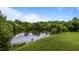 Scenic view of a serene pond surrounded by lush greenery and trees in a park-like setting at 5200 Mrs Fuller Rd, Mebane, NC 27302