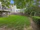 A well maintained backyard features lush green grass, a wood fence and a raised deck area at 5942 Big Nance Dr, Raleigh, NC 27616