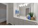 Bathroom vanity with white countertop, framed mirror, and blue towels and decor at 5942 Big Nance Dr, Raleigh, NC 27616