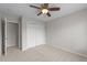 Neutral bedroom featuring a closet, ceiling fan with light, and door to other rooms at 5942 Big Nance Dr, Raleigh, NC 27616