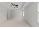 Spacious bedroom with neutral walls, plush carpeting, tray ceiling, and a ceiling fan at 5942 Big Nance Dr, Raleigh, NC 27616