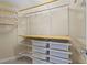 Walk-in closet with custom shelving and metal storage baskets at 5942 Big Nance Dr, Raleigh, NC 27616