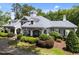 Community clubhouse featuring stone accents, shutters, and well manicured landscaping at 5942 Big Nance Dr, Raleigh, NC 27616