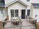 Deck with outdoor dining set, a black metal railing and a door leading into the home at 5942 Big Nance Dr, Raleigh, NC 27616
