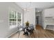 Eat-in dining area features a modern table and chairs near a large, sunny window at 5942 Big Nance Dr, Raleigh, NC 27616