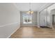 Inviting dining room with wood floors, large window and modern light fixture at 5942 Big Nance Dr, Raleigh, NC 27616