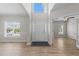 Bright entryway with wood floors, large windows, and a view into other living spaces at 5942 Big Nance Dr, Raleigh, NC 27616
