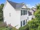 Side view of a two-story home featuring white siding and green shutters at 5942 Big Nance Dr, Raleigh, NC 27616