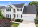 Charming two-story home with a well-maintained lawn, black shutters and a two-car garage at 5942 Big Nance Dr, Raleigh, NC 27616