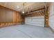 Unfinished garage with storage shelving, brick accents and a roll-up door at 5942 Big Nance Dr, Raleigh, NC 27616