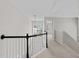 Upstairs hallway with a window and neutral carpeting and paint at 5942 Big Nance Dr, Raleigh, NC 27616