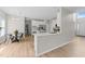 Open concept kitchen with island seating, stainless steel appliances, and a view of the dining area at 5942 Big Nance Dr, Raleigh, NC 27616