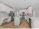 Bright kitchen features an island, stainless steel appliances, white cabinets, and a desk area at 5942 Big Nance Dr, Raleigh, NC 27616