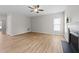 Living room with neutral walls, a ceiling fan, a fireplace and wood-look flooring at 5942 Big Nance Dr, Raleigh, NC 27616