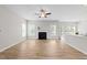 Spacious living room featuring wood-look floors, a fireplace and abundant natural light at 5942 Big Nance Dr, Raleigh, NC 27616