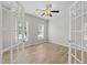 Versatile room with wood floors, French doors, ceiling fan, and natural light at 5942 Big Nance Dr, Raleigh, NC 27616