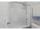 Bright bathroom featuring a white fiberglass shower with a shower head and faucet at 5942 Big Nance Dr, Raleigh, NC 27616