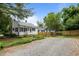Spacious backyard featuring a gravel area, fire pit, and newly-built wooden fence at 601 Acorn St, Burlington, NC 27215