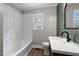 Bathroom featuring subway tiled walls, modern fixtures, and lots of natural light at 601 Acorn St, Burlington, NC 27215