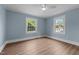 Bright bedroom featuring two large windows and updated flooring at 601 Acorn St, Burlington, NC 27215