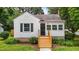 Home exterior boasts a new front deck, black shutters, and verdant landscaping at 601 Acorn St, Burlington, NC 27215