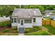 Charming home featuring a covered porch with steps and established landscaping at 601 Acorn St, Burlington, NC 27215