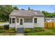 Charming home featuring a covered porch with steps and established landscaping at 601 Acorn St, Burlington, NC 27215
