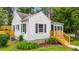 Home's side elevation features vinyl siding, black shutters, and a wooden porch at 601 Acorn St, Burlington, NC 27215