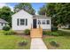Charming home featuring a welcoming front porch, neat landscaping, and a freshly painted exterior at 601 Acorn St, Burlington, NC 27215