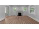 Inviting living room with a classic fireplace, neutral paint, and durable flooring at 601 Acorn St, Burlington, NC 27215