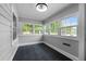 Bright sun room with lots of windows and dark tile flooring at 601 Acorn St, Burlington, NC 27215