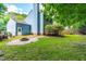 Inviting backyard featuring a brick fire pit, a well-maintained lawn and a wooden deck perfect for entertaining at 6104 New Market Way, Raleigh, NC 27609