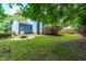 Backyard featuring a fire pit, wooden deck, and a lush yard with mature trees at 6104 New Market Way, Raleigh, NC 27609