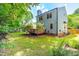 Expansive backyard with a wooden deck, lush greenery, and a well-maintained lawn providing an outdoor oasis at 6104 New Market Way, Raleigh, NC 27609