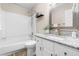 Bathroom featuring a granite countertop, new sink fixtures, and a tub with shower at 6104 New Market Way, Raleigh, NC 27609