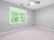 Bright bedroom featuring new carpet, large window, and a ceiling fan at 6104 New Market Way, Raleigh, NC 27609
