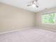Bright bedroom with new carpet, a ceiling fan, and a large window with a view at 6104 New Market Way, Raleigh, NC 27609